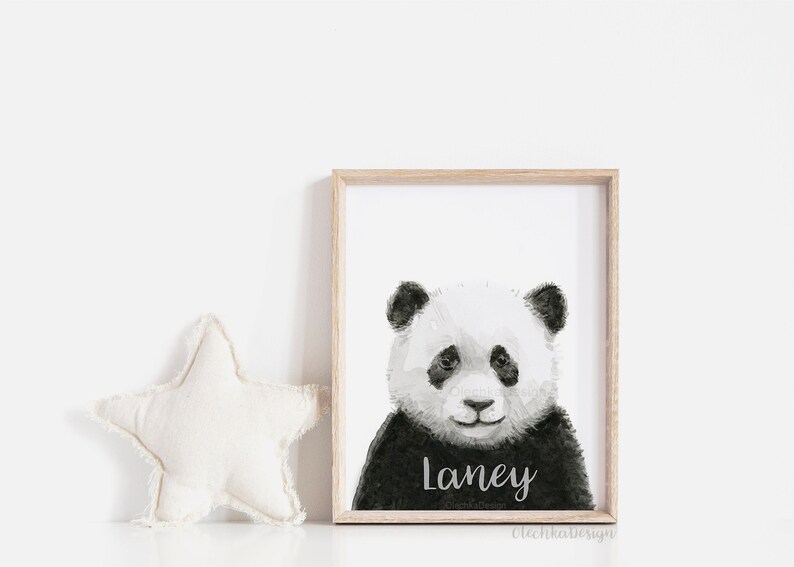 May include: Black and white watercolour illustration of a panda bear with the name "Laney" written below. The illustration is framed in a light wood frame.