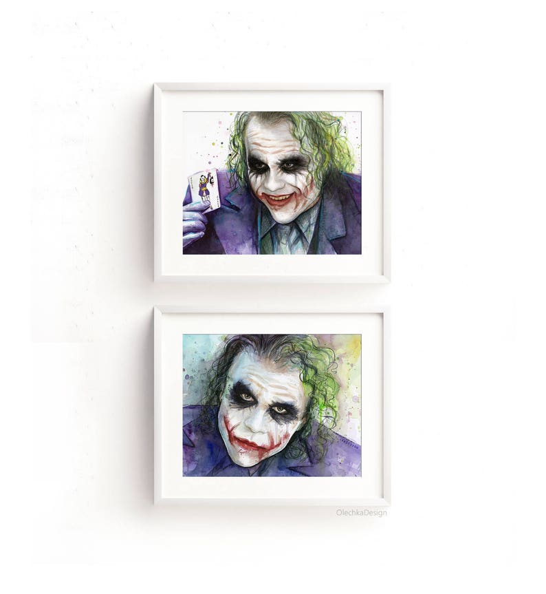 May include: Two framed watercolour paintings of the Joker from the film The Dark Knight. The Joker is depicted with a green and purple colour scheme, a sinister smile, and a green and purple suit. The top painting shows the Joker holding a playing card. The bottom painting shows the Joker's face close up.