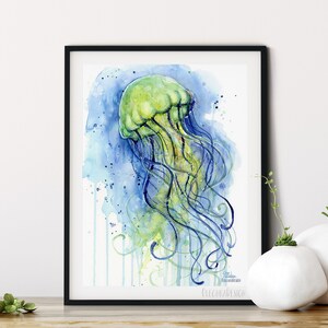 May include: Watercolor painting of a green jellyfish with blue tentacles against a blue and white background. The painting has a watercolor drip effect.