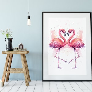 May include: A watercolor painting of two pink flamingos facing each other with their necks forming a heart shape. The background is a soft pink watercolor wash.