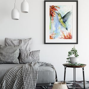 May include: Watercolor painting of a hummingbird in flight, drinking nectar from a red flower. The background is a soft blue with splashes of color.