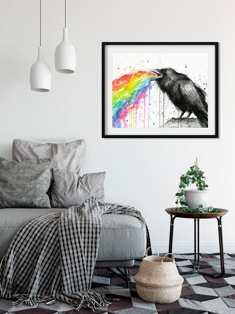 May include: A black and white watercolor painting of a raven with a rainbow coming out of its mouth. The raven is perched on a rock and the rainbow is dripping down.