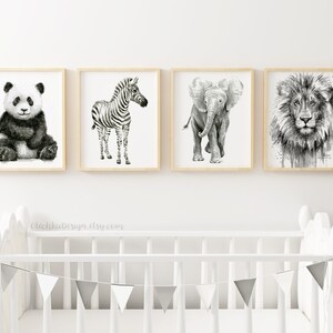 May include: Set of four black and white animal illustrations in wooden frames. The illustrations depict a panda, zebra, elephant, and lion.