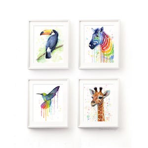 May include: Set of four watercolor animal prints featuring a toucan, zebra, hummingbird, and giraffe. Each animal is depicted in a colorful, abstract style with splashes of paint.
