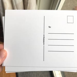 May include: Blank white postcard with a space for an address and a stamp. The postcard has the text "www.clothanddesign.com" and "To:" printed on the back.
