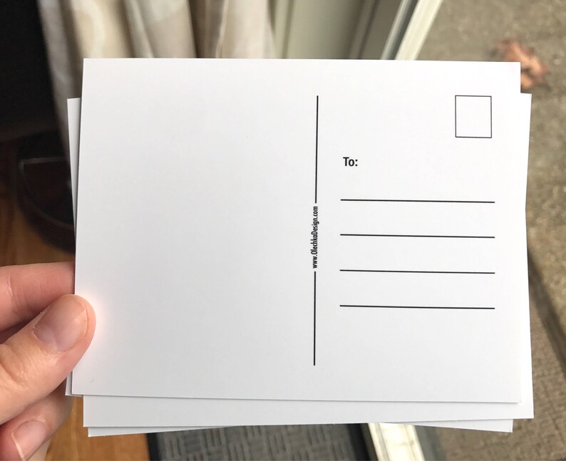 May include: Blank white postcard with a space for an address and a stamp. The postcard has the text "www.clothanddesign.com" and "To:" printed on the back.