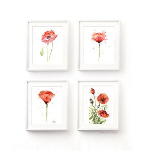 May include: Set of four watercolor paintings of red poppies in white frames. Each painting features a single poppy flower with green stems and leaves. The paintings are arranged in a grid pattern on a white background.