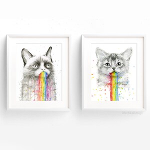 May include: Two framed watercolor paintings of cats vomiting rainbows. The cat on the left is a grumpy cat with a black and white face. The cat on the right is a white cat with gray markings. Both cats have a rainbow coming out of their mouths.