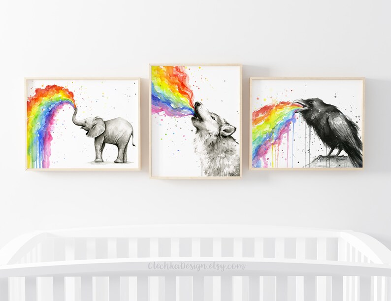 May include: Three watercolor paintings of animals blowing rainbows. The first painting shows an elephant blowing a rainbow. The second painting shows a wolf blowing a rainbow. The third painting shows a raven blowing a rainbow.