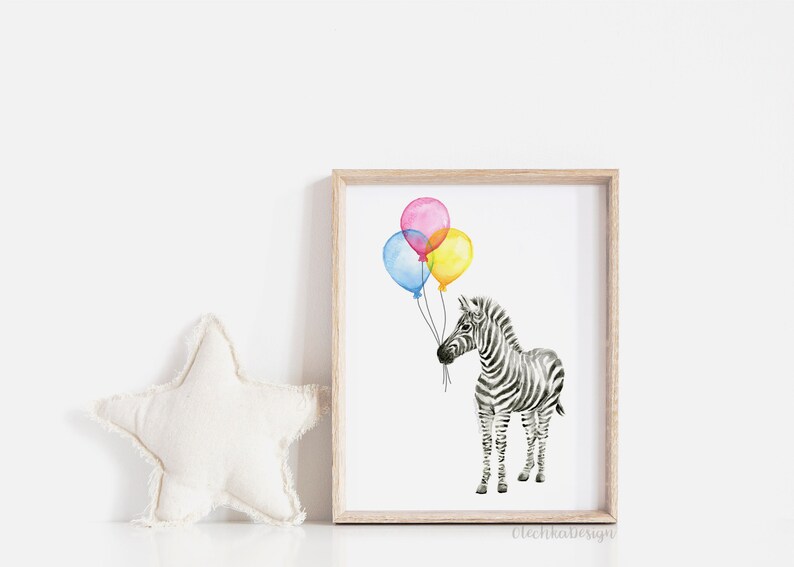 May include: Watercolor print of a zebra holding three colorful balloons. The balloons are pink, yellow, and blue. The zebra is black and white with a light brown wooden frame. The print is on a white background.