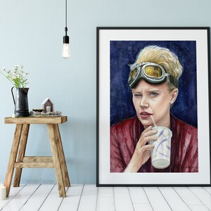 May include: Watercolor painting of a woman wearing aviator goggles and a red shirt, holding a cup with a straw. The background is a dark blue with white stars.