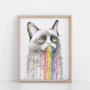 May include: A watercolor painting of a grumpy cat with a rainbow coming out of its mouth. The cat is drawn in shades of gray, and the rainbow is colorful with shades of red, orange, yellow, green, blue, indigo, and violet. The background is white.