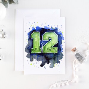 May include: Watercolor painting of the number 12 in green and blue with a cityscape silhouette inside the number. The background is a dark blue with white splatters. The text "OlechkaDesign" is in the bottom right corner.