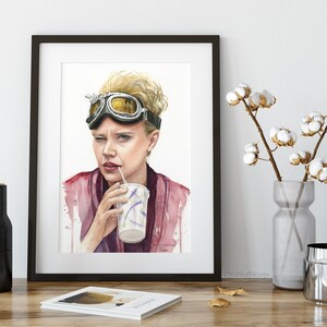 May include: Watercolor painting of a woman wearing aviator goggles and a pink shirt, drinking from a paper cup with a straw.