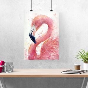 May include: A watercolor painting of a pink flamingo with a blue beak, standing on one leg with its head tucked into its feathers. The background is a light wash of pink and white with splatters of color.