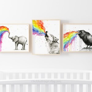 May include: Three watercolor paintings of animals blowing rainbows. The first painting shows an elephant blowing a rainbow. The second painting shows a wolf blowing a rainbow. The third painting shows a raven blowing a rainbow.