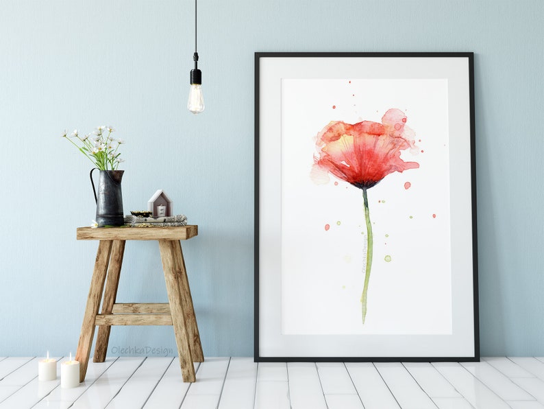 May include: A watercolor painting of a single red poppy flower with a green stem and leaves. The background is white with light pink and green watercolor splatters.