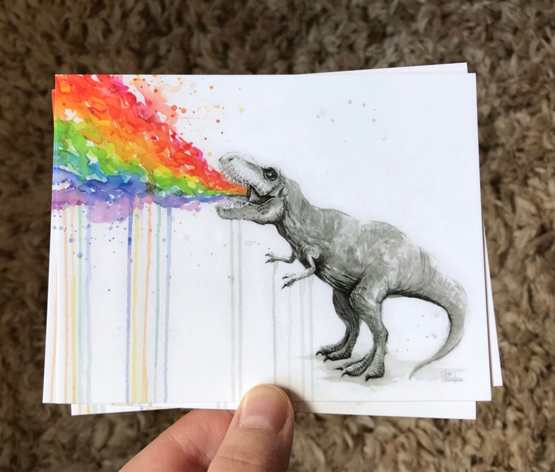 May include: A watercolor painting of a dinosaur blowing a rainbow out of its mouth. The rainbow is made up of different shades of red, orange, yellow, green, blue, indigo, and violet. The dinosaur is drawn in black and white.