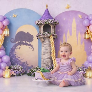 May include: A baby girl in a lavender dress and a gold tiara smiles in front of a fairytale backdrop. The scene includes a cake with a green frog, a tower, balloons, and a castle illustration, creating a whimsical birthday theme.