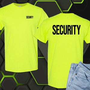 May include: A neon yellow short-sleeved t-shirt featuring the word SECURITY printed in black on the left chest and in a larger font size on the back. The shirt is displayed in two views, showing both the front and the back of the garment.