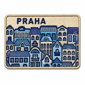 May include: A rectangular embroidered patch featuring a cityscape of Prague with the text PRAHA in dark blue. The design showcases various buildings in shades of blue and cream, with a thick, tan-colored stitched border framing the entire piece.