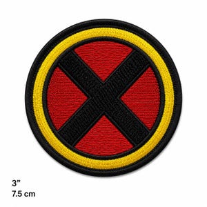 May include: A circular embroidered patch featuring a black X shape centered over a red background, enclosed by a thick yellow border and a thin black outer edge. The patch measures 3 inches in diameter as indicated by the text in the corner.