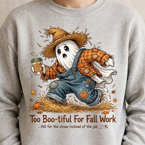May include: A light gray sweatshirt featuring a cartoon ghost wearing a straw hat and plaid shirt with blue overalls, holding a pumpkin spice latte. The graphic includes scattered autumn leaves and the text "Too Boo-tiful For Fall Work".