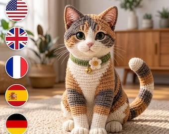 May include: A crocheted calico cat figurine featuring a tricolor pattern of white, orange, and dark gray yarn. The cat wears a green crocheted collar adorned with a small white flower and a tiny gold-colored bell hanging from the center.