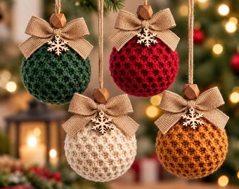 May include: Four spherical Christmas ornaments featuring a textured crochet pattern in dark green, red, cream, and mustard yellow. Each ornament is topped with a tan burlap bow, a small wooden bead, and a wooden snowflake charm hanging from twine.