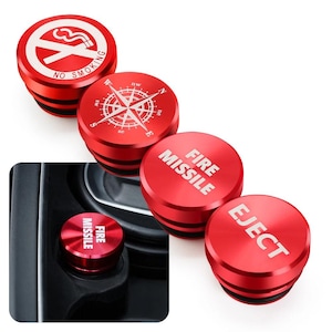 May include: Four circular red metal car cigarette lighter plugs. One features a no smoking symbol, one a compass rose, one the text FIRE MISSILE, and one the text EJECT. One plug is shown inserted into a black vehicle console socket.