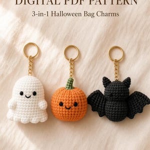 May include: A digital PDF pattern for 3-in-1 Halloween bag charms featuring a white crocheted ghost, an orange crocheted pumpkin with a green stem, and a black crocheted bat, each attached to a gold-toned metal keyring and chain.