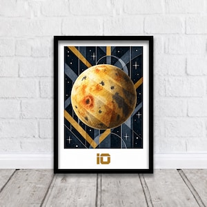 May include: A framed wall art print featuring a textured, golden-yellow sphere resembling the moon Io against a dark blue background with geometric gold lines and small white stars. The text IO is printed in gold at the bottom of the print.
