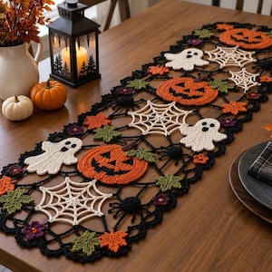 May include: A rectangular crochet table runner featuring a black lattice border with orange pumpkins, white ghosts, white spiderwebs, black spiders, and green and orange autumn leaves. The intricate design is crafted with yarn.