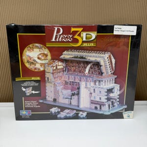 May include: A Puzz 3D Plus Sistine Chapel 3-D puzzle box featuring a graphic of the assembled model with interior and exterior views of the chapel. The box includes the text Puzz 3D Plus, Michelangelo, and Sistine Chapel, Chapelle Sixtine, Capilla Sixtina, Sixtinische Kapelle.
