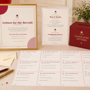 May include: A Letters for the Recruit station featuring a framed sign, a How It Works instruction card, a maroon box labelled Completed Letters, cream envelopes, two pens, and a sheet of twelve prompt cards with headings like Advice for Boot Camp.