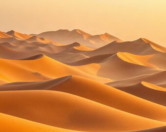 May include: A vast desert landscape featuring rolling sand dunes in shades of golden orange and deep amber. The undulating terrain creates a series of sharp ridges and soft, sweeping curves that extend toward a hazy, light-colored horizon line.