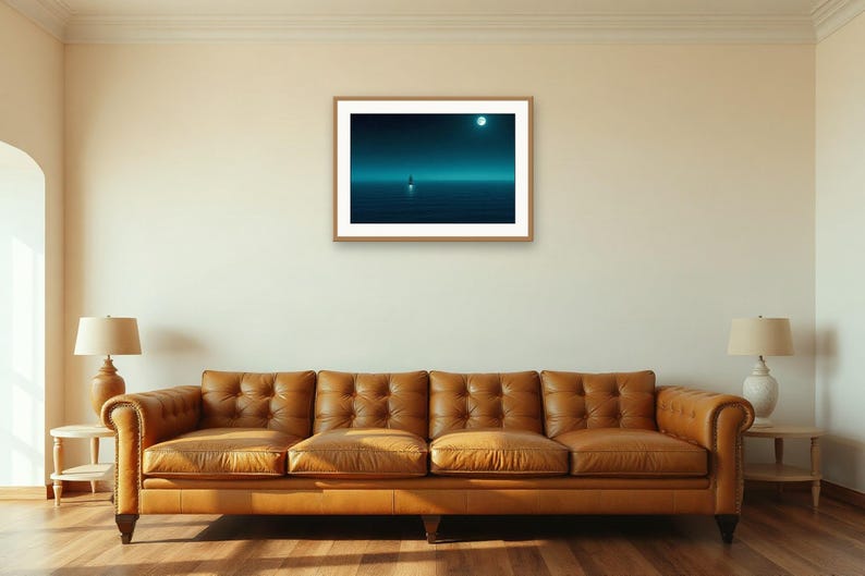 May include: A rectangular framed wall art print featuring a dark blue night seascape with a small boat on the water under a bright full moon. The artwork is displayed in a light wood frame and is centred on a plain off-white interior wall.
