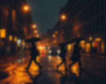 May include: A blurry, out-of-focus night scene of a city street during rain. Three dark silhouettes of people walk across a wet road, each holding an umbrella. The background features glowing yellow streetlights and illuminated storefront windows.