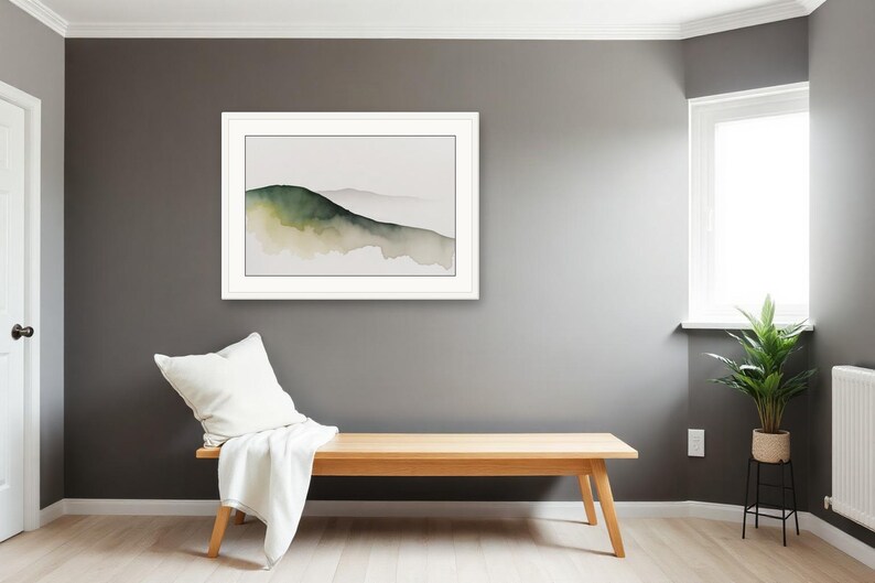 May include: A framed landscape wall art print featuring a watercolour painting of rolling hills in shades of dark green and muted beige against a light background, displayed in a white frame with a clean, simple border design.