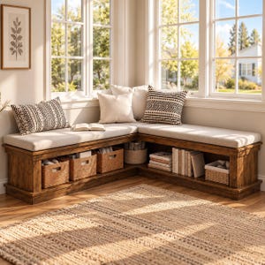 May include: An L-shaped wooden corner bench with a light beige cushion, featuring open storage shelves underneath. The bench includes three woven baskets, a stack of books, and three decorative throw pillows with black and white patterns.