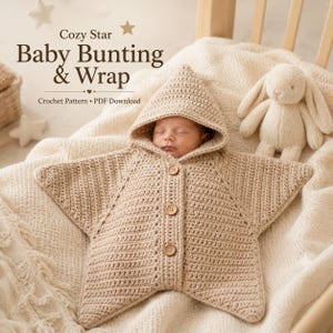 May include: A beige crochet baby bunting and wrap in a star shape with a hood and three wooden buttons. The text Cozy Star Baby Bunting & Wrap Crochet Pattern PDF Download is visible. A plush rabbit toy sits nearby on a textured white blanket.