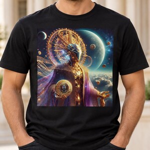 May include: A black short-sleeved t-shirt featuring a vibrant, detailed graphic print of a celestial figure adorned in gold armour and purple robes, set against a cosmic background with planets, floating orbs, and a large glowing circular structure.