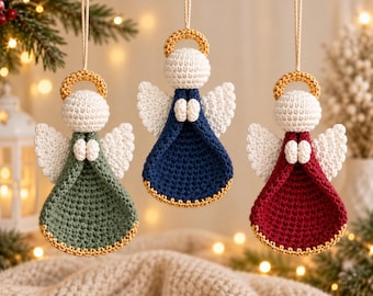 May include: Three crocheted angel ornaments hanging by strings. Each angel features a white head, white wings, small white hands, and a gold halo. The dresses are solid sage green, navy blue, and deep red, each finished with a gold-colored trim.