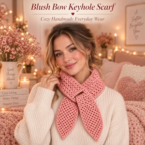 May include: A blush pink crochet keyhole scarf featuring a textured stitch pattern. The scarf is designed with a loop that allows one end to pass through the other, creating a bow-like shape. The text Blush Bow Keyhole Scarf is visible.