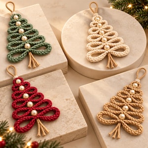 four handmade Christmas tree ornaments, each crafted from yarn and adorned with small pearls. The ornaments are arranged on a beige surface, surrounded by pine branches and pine cones, creating a festive and holiday atmosphere.