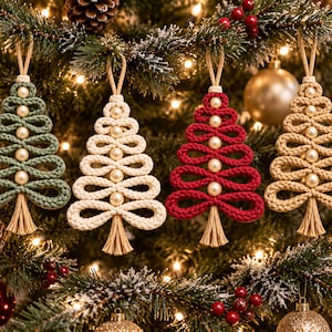 a beautifully decorated Christmas tree adorned with four crocheted Christmas tree ornaments in various colors and sizes, including green, white, red, and gold. The ornaments are hanging from the tree branches, creating a festive and cozy atmosphere.
