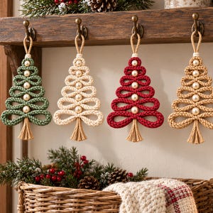 A collection of crocheted Christmas tree ornaments in various colors, including green, white, red, and beige, hanging on a wooden shelf.