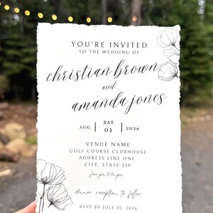 May include: A white wedding invitation card with deckled edges featuring black printed text and delicate floral line art. The text reads: YOU'RE INVITED TO THE WEDDING OF christian brown and amanda jones, AUG 01 2026, VENUE NAME, GOLF COURSE CLUBHOUSE, ADDRESS LINE ONE, CITY, STATE ZIP, four pm to ten pm, dinner reception to follow, RSVP BY JULY 01, 2026.