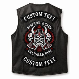 May include: A black leather vest featuring a large embroidered back patch with a central horned skull wearing a helmet, flanked by two skulls and crossed axes. The patch includes the text "BERSERKER CREW" and "VALHALLA RIDE" with two additional "CUSTOM TEXT" banners.