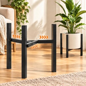 May include: A black metal adjustable plant stand with four vertical legs and a cross-shaped base. The frame features sliding components to accommodate different pot sizes, highlighted by orange arrow graphics indicating the expansion range.